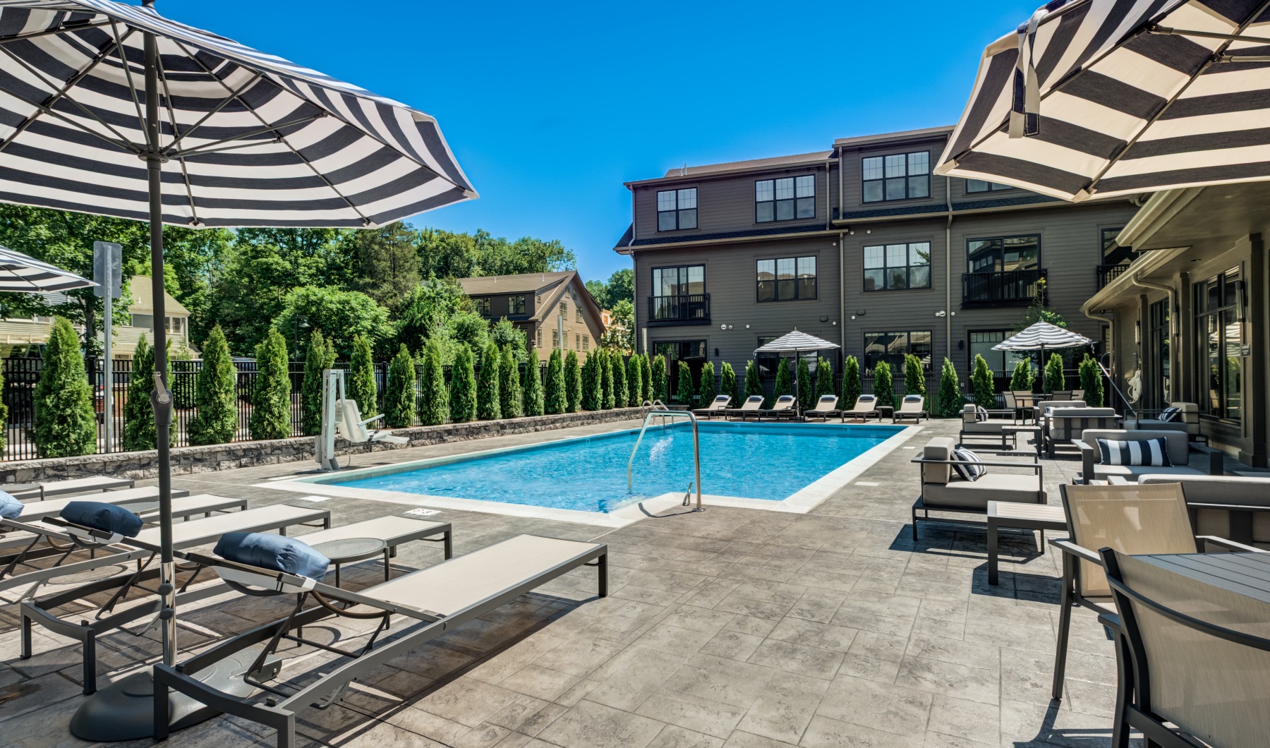 Sparkling resort-style swimming pool and outdoor lounge area at Brookside Wilton luxury apartments in Connecticut