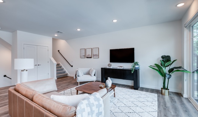 Staged model apartment living room showcasing modern furniture, open layout, and luxury finishes at Brookside Wilton in CT