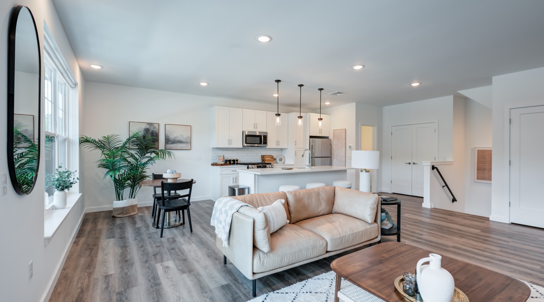Bright open-concept apartment living room and kitchen interior at Brookside Wilton in Connecticut
