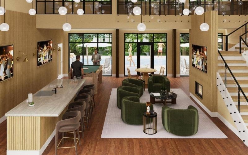 a clubroom with chairs, a bar, tv's and a fireplace