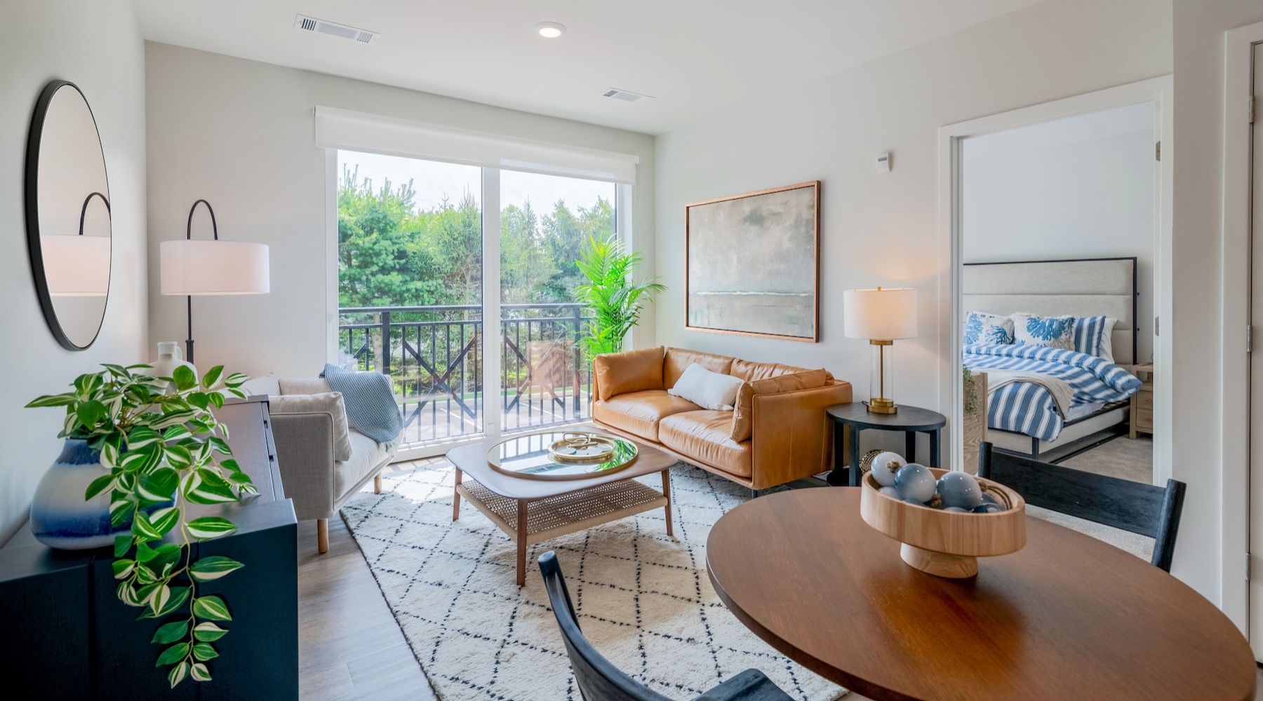a living room with a couch, tables and chairs