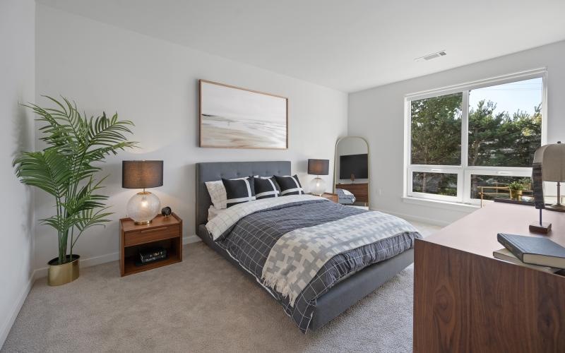 a bedroom with a bed and a desk