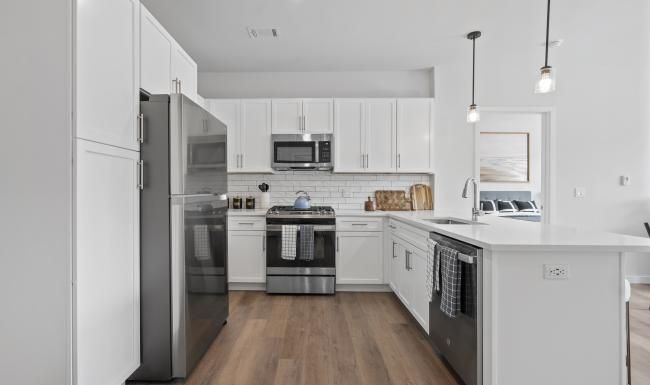 a kitchen with white cabinets